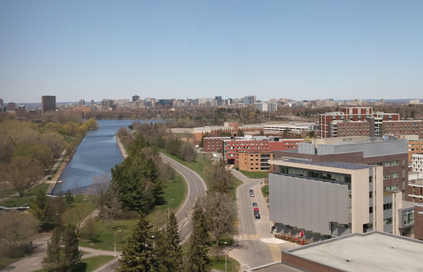 A photo of Carleton University taken by the author from an upper floor of Dunton Tower in 2016, showing the edge of the university campus and Dow’s Lake along the Rideau Canal.